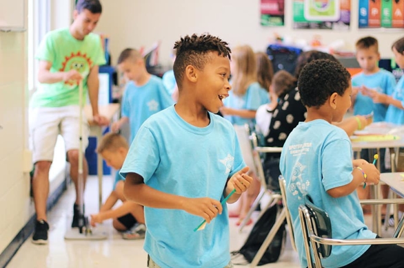 67081597_2712082495684744_6403596028435496960_n Space camps: A young boy interacts with other students in a classroom.